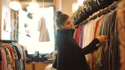 Female shopper reviews various textiles and colors attentively in store - Powered by Adobe