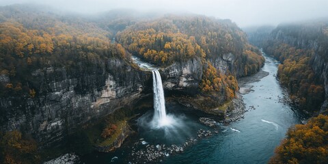 Bird's-eye view of a waterfall flowing into a river highlighting water erosion processes, Earth Day
