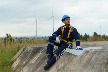Engineering technicians are working to check the operation of wind turbines in a wind farm and check the electricity.(PHOTO)