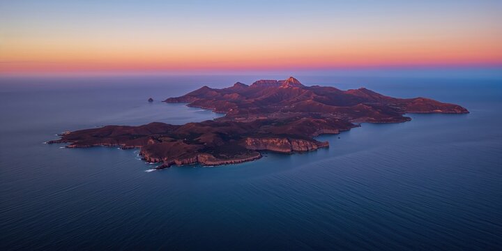 Aerial view of islands at sunset with water and mountain scenery, ideal for travel and nature backgrounds