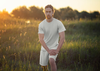 Mockup of white t-shirt, shorts on long-haired bearded man, front view, suit for design, pattern, branding.
