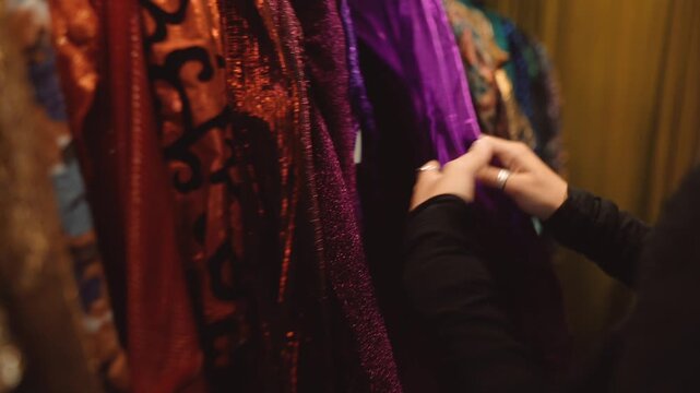 Caucasian fashionista checks vibrant sequin jacket details carefully