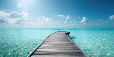 Fototapeta premium Weathered wooden platform by the vibrant blue sea with surf and sky, emphasizing vacation leisure, World Oceans Day