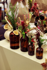 Rustic Dried Floral and Botanical Arrangements in Assorted Amber Glass Bottles, Apothecary Style Display