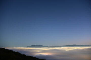 beautiful city lights through the fog and clouds