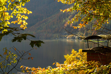 Autumn Lake Landscape with Sunlit Foliage and Mountain Village