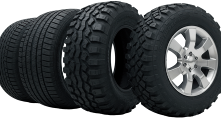 three hyperdetailed black vulcanized rubber car tires (all-season, mud-terrain, touring) on alloy rims, isolated on pristine white for copy space. concept for automotive advertising