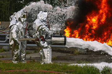 Firefighters use a foam generator to supply foam to extinguish the fire. A fire at the plant caused by the ignition of an oil product. Firefighters extinguish a fire at an oil refinery.