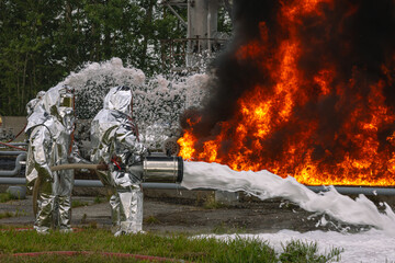 Firefighters use a foam generator to supply foam to extinguish the fire. A fire at the plant caused by the ignition of an oil product. Firefighters extinguish a fire at an oil refinery.