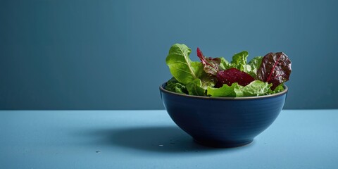Chard salad served in a blue bowl on a blue background, suitable for fresh vegetable dishes