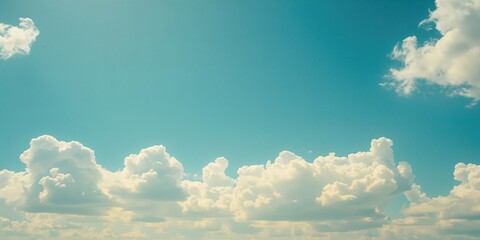 Clear sky with fluffy clouds, ideal for editorial header backgrounds