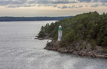 A lighthouse on a rocky cliff. Fairway between the islands of the Stockholm archipelago, Sweden.
