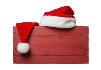 A richly textured red velvet santa hat draped over a rustic distressed wooden sign, isolated on a bright white commercial backdrop. Vintage holiday cheer concept