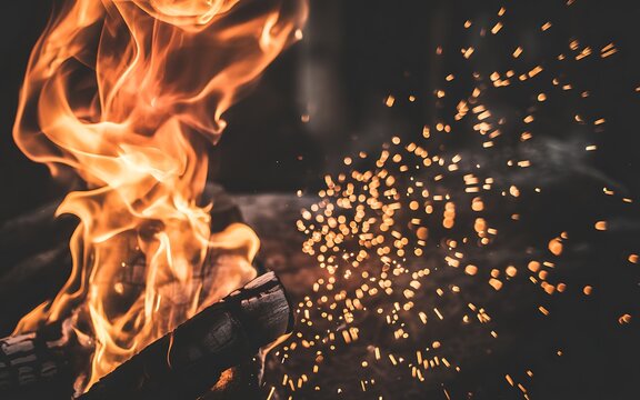 A captivating close up of a vibrant campfire with glowing embers and flames - Powered by Adobe