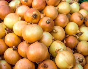 A close-up view presents a pile of round, golden-brown vegetables, each with a papery outer layer and a textured surface