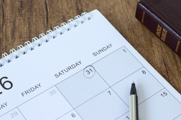 Calendar and holy bible book on wooden table. Sabbath day rest, Christian biblical concept.
