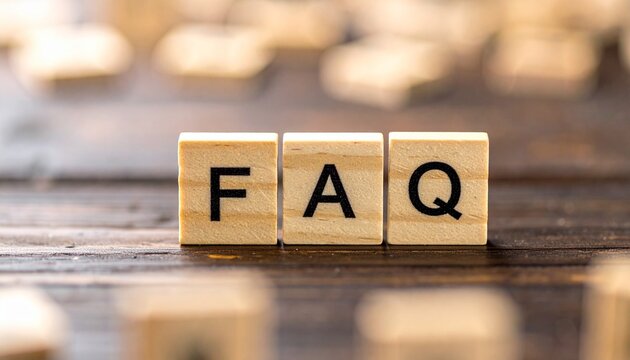 FAQ (Frequently Asked Questions) Spelled on Wooden Blocks on Dark Wood Table
