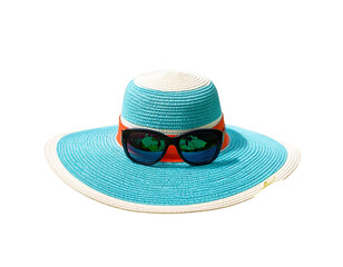 Stylish summer hat and sunglasses among tropical leaves