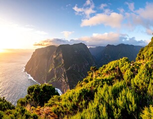 A coastal landscape at dawn shows lush greenery on a cliff edge, overlooking ocean and majestic mountain ranges under a cloudy sky