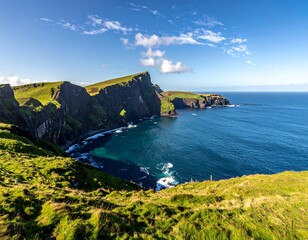 A coastal landscape featuring dramatic cliffs meeting the ocean under a partly cloudy, bright sky, showcasing natural beauty
