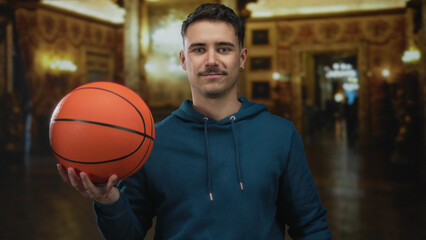 Young hispanic man holding basketball inside an ornate museum setting, blending sports with culture.