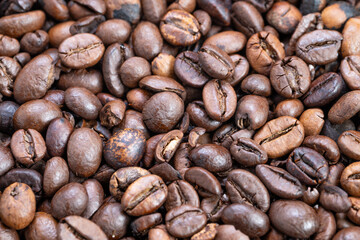 Coffee bean closeup, Roasted beans surface details, Zoomedin view emphasizing coffee bean textures, Close examination revealing cracking and surface intricacies of beans