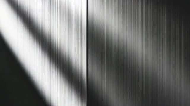 Close-up of sleek metallic panels showcasing a smooth gradient from light to dark with dynamic shadows creating a textured play of light on the surfaces throughout various lighting conditions