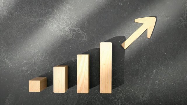 Wooden blocks arranged in ascending order create a visual representation of growth with an upward arrow placed on a textured dark background illuminated by soft natural light