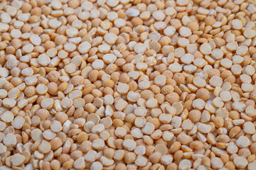 Detailed closeup of vibrant split peas showcases natural texture, Highresolution image features rustic yellow pea groats with granular surface and natural appeal