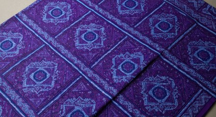 A patterned textile with geometric designs in shades of blue and purple
