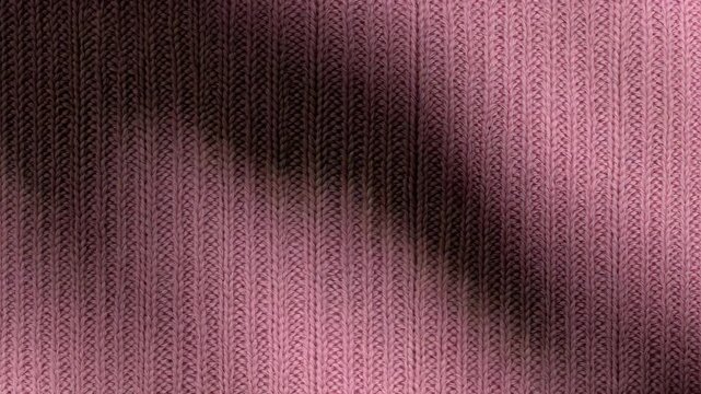 Pink ribbed knit fabric background with gentle shadow sweep and copy space