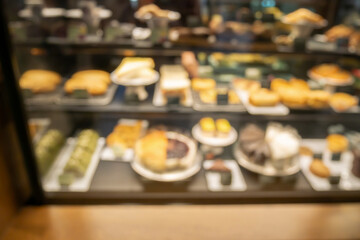 Abstract blur bakery display showcase of cakes pastries in cafe coffee shop