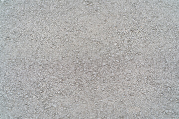 Fototapeta premium A flat surface of gray gravel with small stones under sunlight during daytime