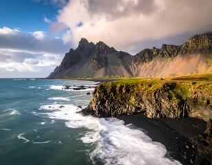 A coastal scene showcases rugged mountains rising from the sea, with a black sand beach and crashing waves under a cloudy sky