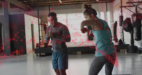 Trainer cueing with timer watching boxer punching jabs and slipping red overlay showing form