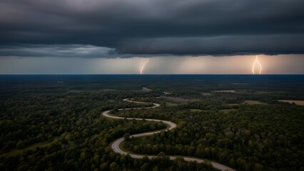 Lightning strikes over a winding road through a forest under a stormy sky.