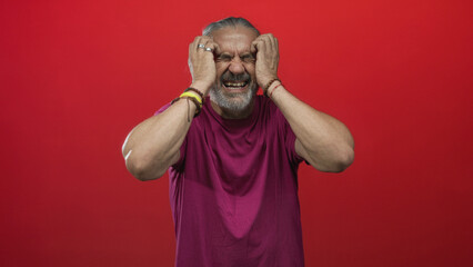 Man middle aged with hoary long hair holding temples with both hands for headache in studio with...