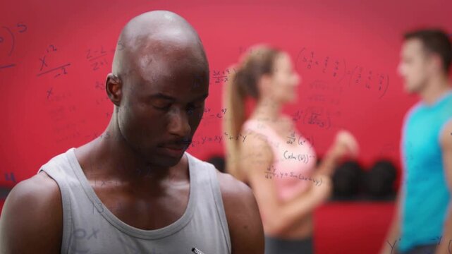 Man noting stats in gym red-wall weights, camera shifting focus, math scribbles overlaying, smiling