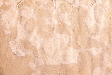 Macro shot of distressed brown parchment with scattered splashes and ageing stains