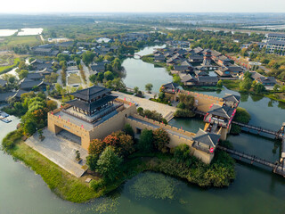 Ancient structures stand by water showing traditional Chinese architecture in Xiantao City, Hubei Province, China.