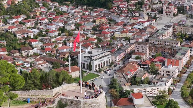 Aerial view of Berat with the Albanian flag flying proudly on the hilltop platform overlooking the city and Osum River.