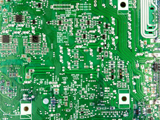 A close-up of a circuit board with microchips from an electrical appliance or computer. Concept of modern technology. Concept of electronics and microchips.