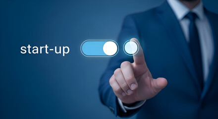 Businessman in blue suit activating start up switch with finger