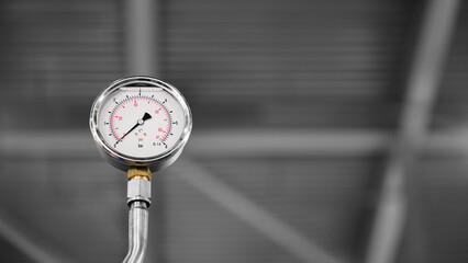 Pressure gauge in large industrial stainless steel machine used in food or pharmaceutical industry, industrial cleanliness concept background