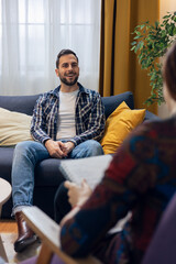 Fototapeta premium Man talking during psychotherapy session with therapist