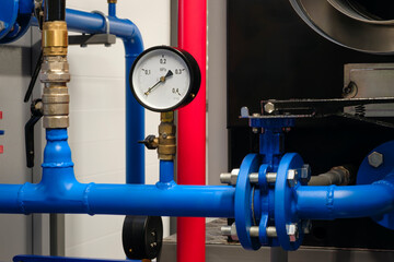 Pressure gauge in large industrial stainless steel machine used in food or pharmaceutical industry, industrial cleanliness concept background