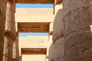 Ancient egyptian temple columns with hieroglyphic carvings. Karnak temple in Luxor, Egypt