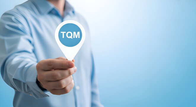 Businessman holding a tqm sign on a blue background for quality management concept