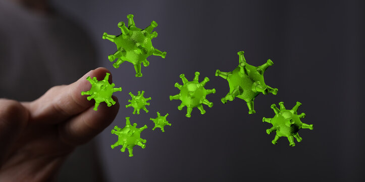 Close up shot of hand with floating green viral particles. Symbolic image for research on health, germs and in