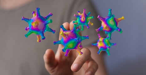 Fototapeta premium Abstract image of a hand interacting with a computer generated colorful virus, representing disease, innovatio